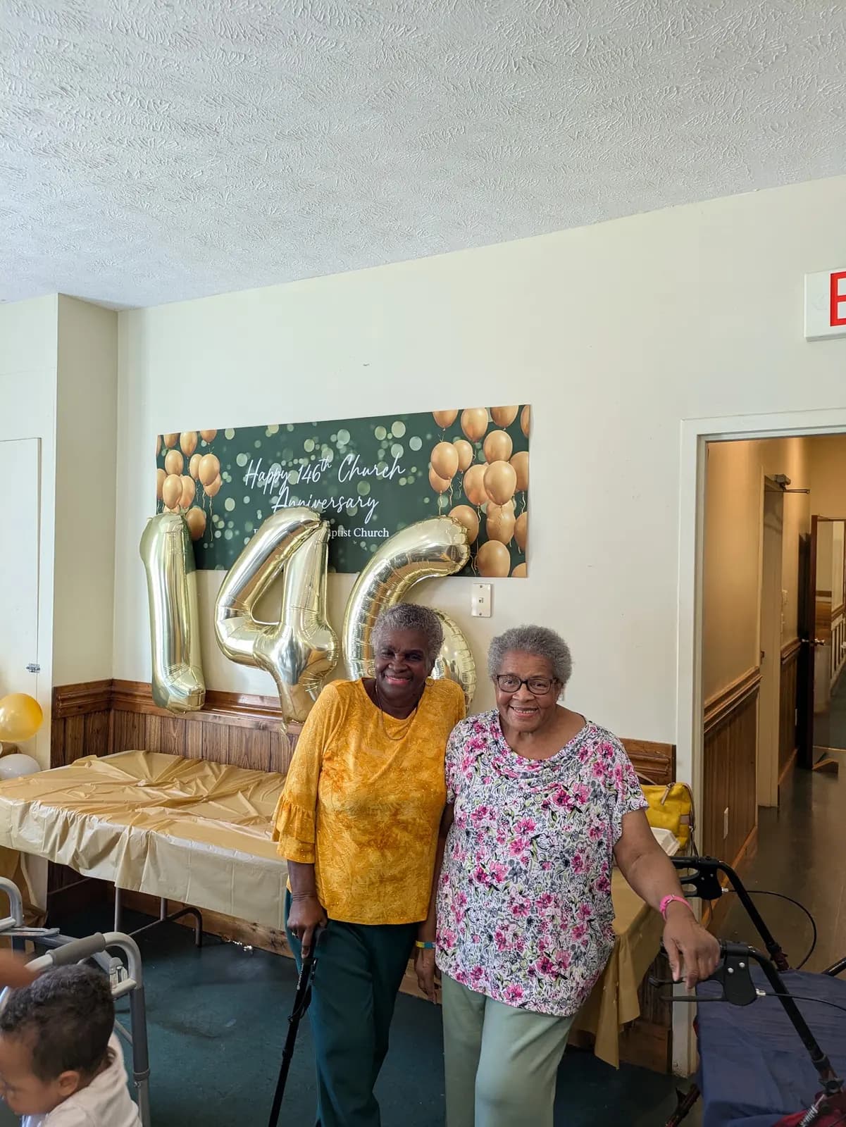 Two longtime members smiling together at the anniversary celebration