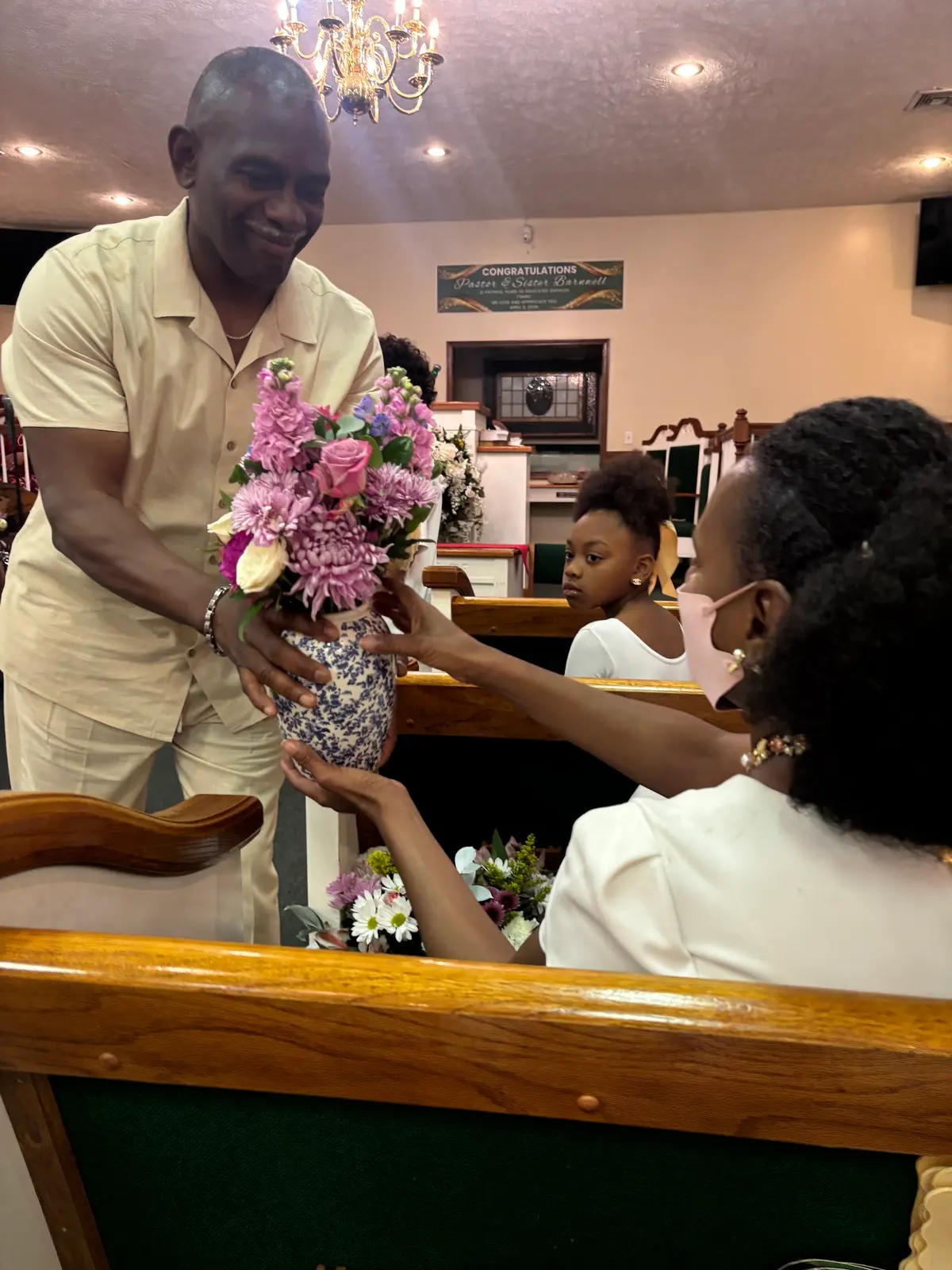 A member presenting Easter flowers in the sanctuary