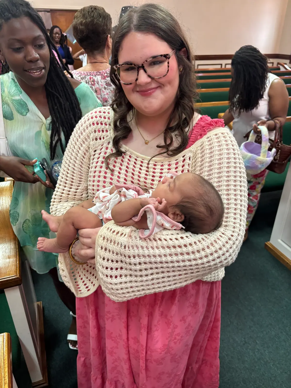 A member holding a newborn in the sanctuary on Easter Sunday