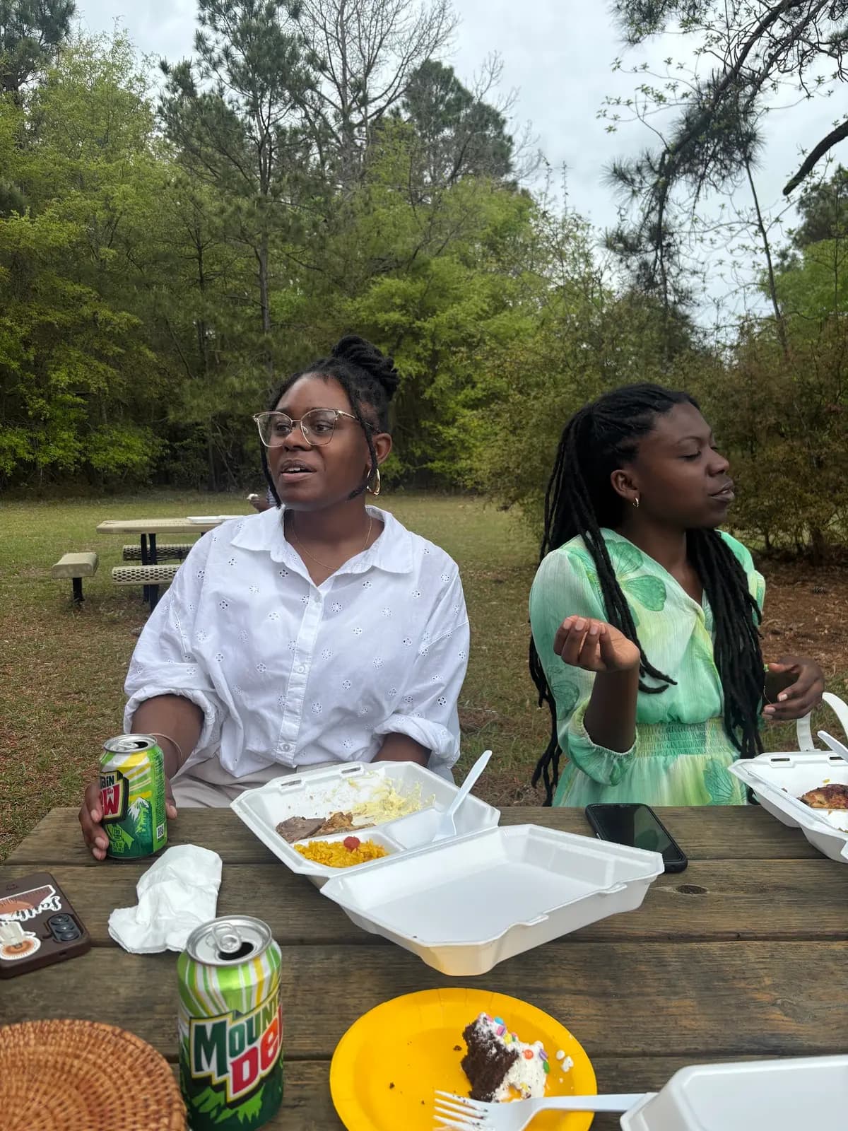 Members enjoying an Easter meal at outdoor picnic tables