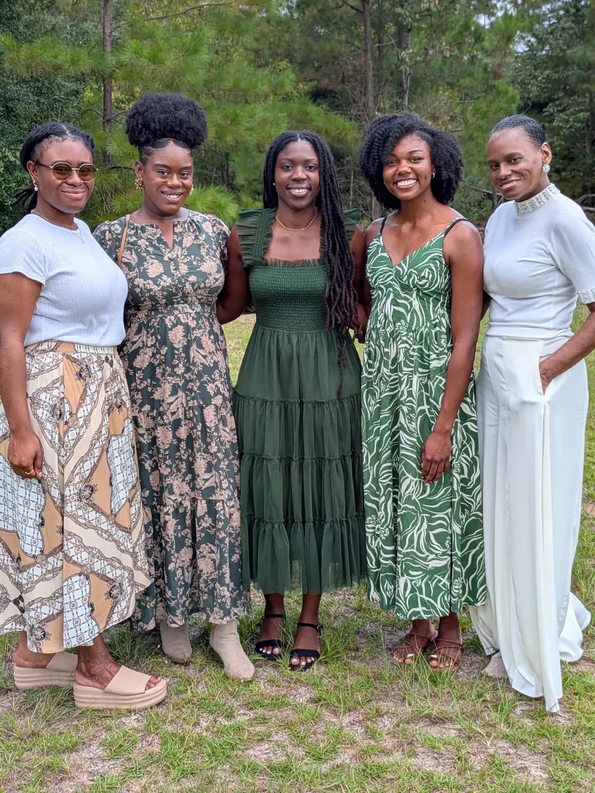 Five women posing together in a field after Sunday service