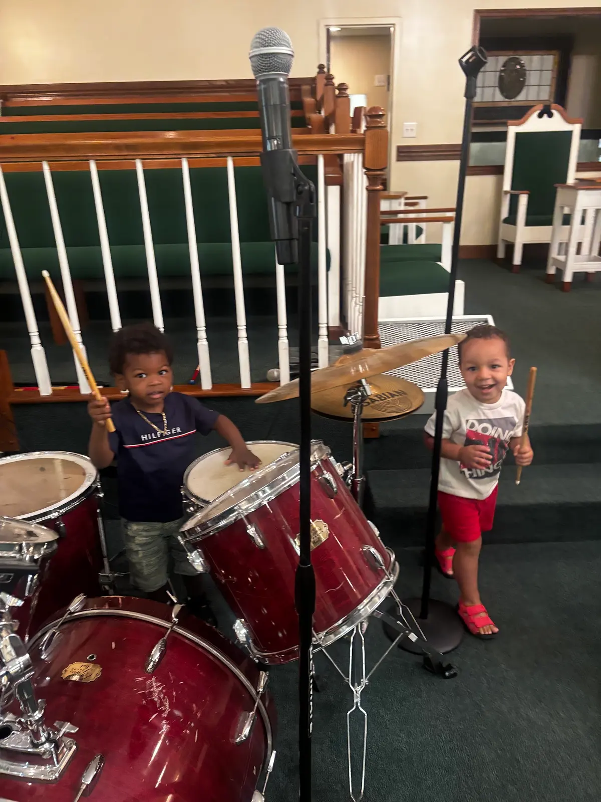 Children trying out the drums in the sanctuary