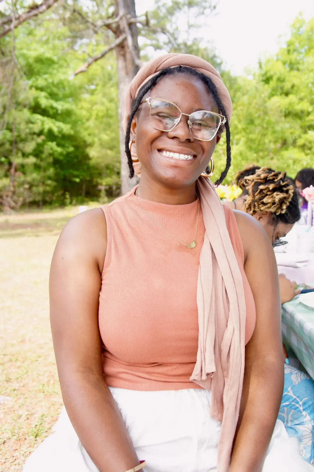 A member smiling at the spring picnic