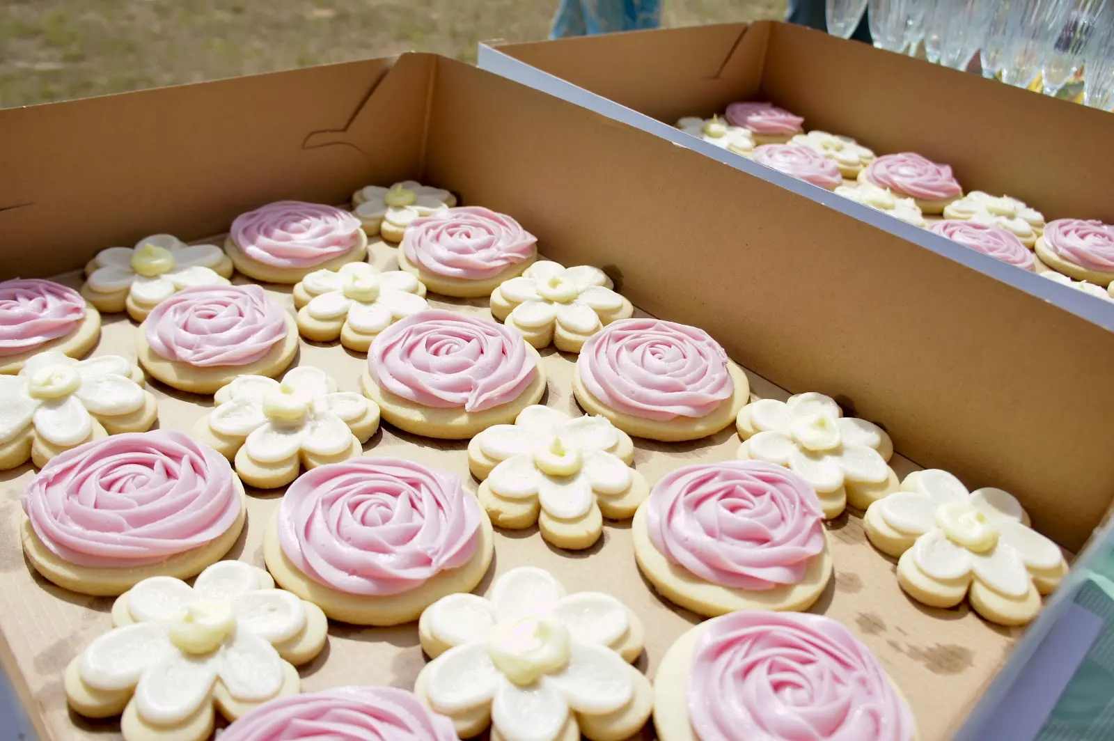 Flower-shaped sugar cookies decorated in pink and white