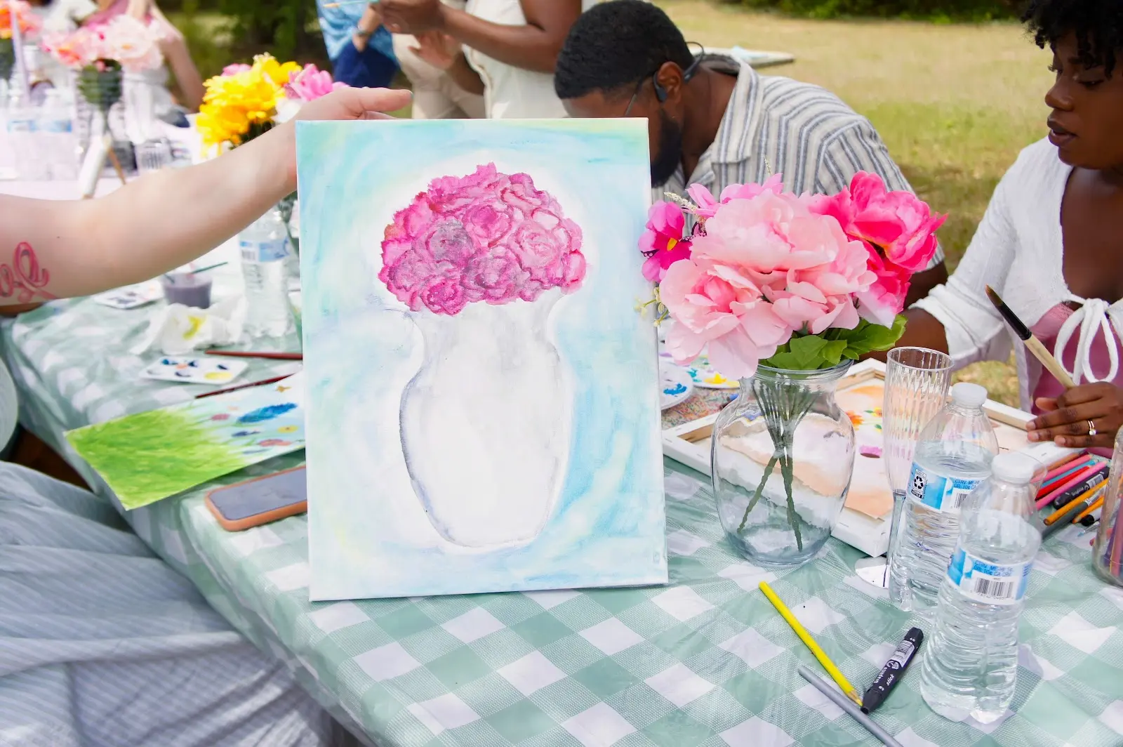 A finished flower painting on the picnic table