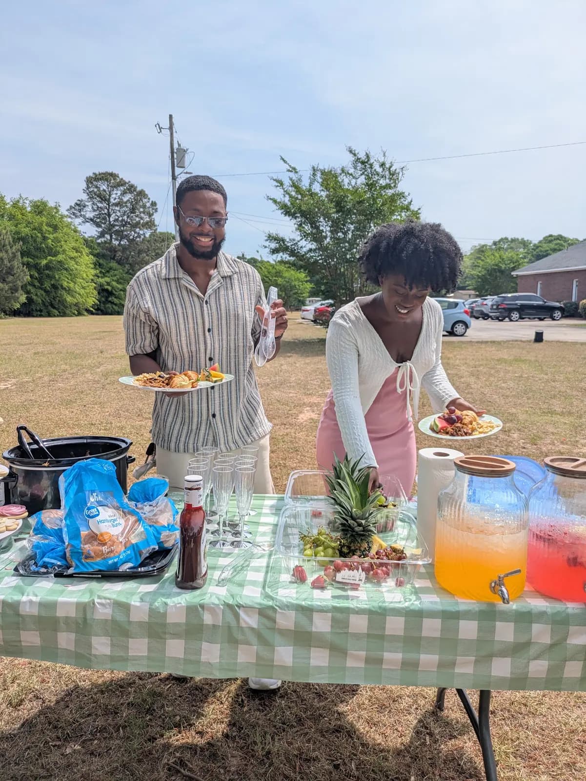 Members serving food at the picnic table